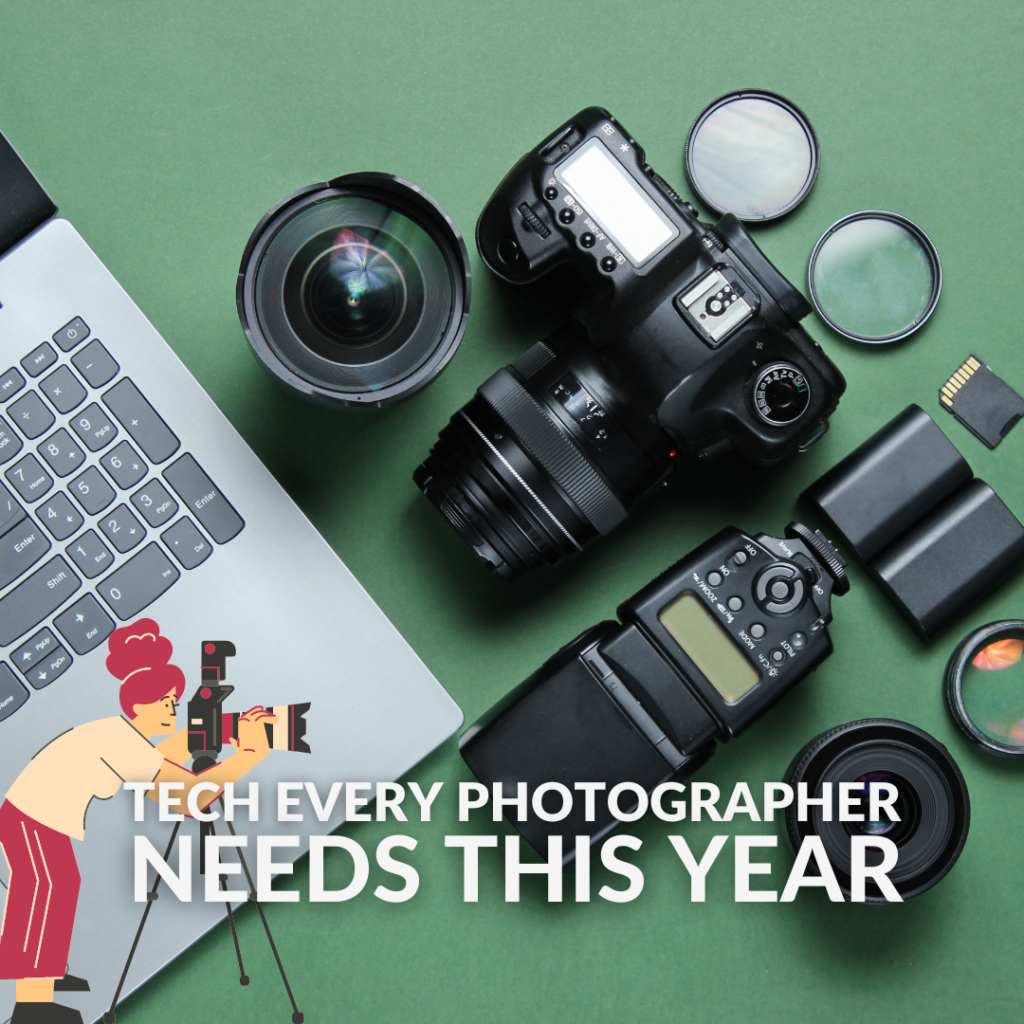 A laptop, DSLR, several lenses and a flash gun sat on a table.